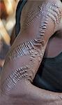 A Pokot man with scarification on his right arm.  This form of body art is quite common among his tribe. The cicatrices are raised by rubbing charcoal or the sap of a plant into them when the wounds are still fresh.