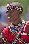 A Maasai schoolboy in traditional attire sings during an inter schools song and dance competition, Kenya