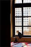 Lebanon, Beirut. A woman reads the Koran in the Mohammed AlAmin Mosque.