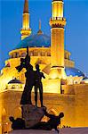 Lebanon, Beirut. Statue in Martyrs Square and Mohammed AlAmin Mosque at dusk.