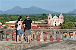 Couple enjoying the view from Cathedral to Iglesia de la Asuncion, Leon, Nicaragua, Central America