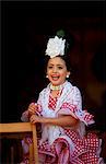 Seville, Andalusia, Spain, A girl in traditional flamenco dress at the Feria de Abril