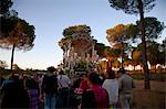 Huelva, Southern Spain. Believers carrying a float with the Madonna, early morning a days distance on foot from the village of El Rocio where the feast takes place