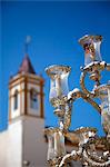 El Rocio, Huelva, Southern Spain. Detail of lamps on a cart and church tower during the annual Romeria