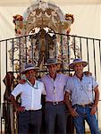 El Rocio, Huelva, Southern Spain. Man in traditional clothes, particpants in the annual Romeria of El Rocio pose in front of one of the floats carried during the feast