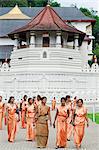 Sri Lanka, Sacred city of Kandy, UNESCO World Heritage Site, women walking outside Temple of the Tooth, Sri Dalada Maligawa