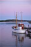 Gothenburg, Sweden. A fishing boat at sunset moored on the island of Branno in Gothenburgs archipelago.