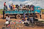 At the conclusion of a market near Puranga, the stallholders pack up their wares in sacks and takes them home by lorry, Uganda, Africa