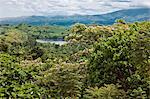 A magnificent view to the distant Rwenzori Mountains from the attractive gardens of Ndali Lodge, Uganda, Africa.