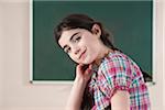 Portrait of Girl in front of Chalkboard in Classroom