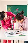 Girls Looking at Flower with Microscope in Classroom, Baden-Wurttemberg, Germany