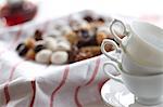 Tea cups and assorted pastry in the background