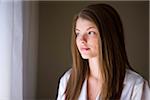 Portrait of Woman with Brown Hair Looking out Window