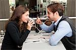 Young Couple in Restaurant Drinking Red Wine