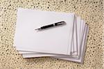 Overhead View of Pen on Stack of Paper
