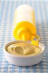 Close-up of Bowl of Mustard and Yellow Squeeze Bottle