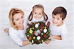 Woman with two kids holding advent wreath - holidays in the family