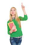 Happy student girl with books pointing up on copy space