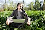 tired student with laptop outdoors