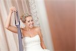 bride playing with necktie