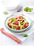 bowl of penne pasta with roasted cherry tomatoes and capers