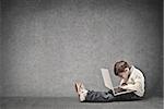 Child concentrated on a laptop in a dark room