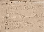 Ancient Egyptian hieroglyphic carvings on a temple wall at Karnak in Luxor