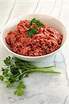 Close up of raw ground beef on marble cutting board