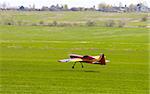 RC model airplane lands on the grass field