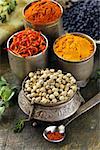 various spices (turmeric, paprika, saffron, coriander) in metal bowls