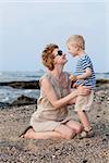 smiling happy mother and her son at the beach