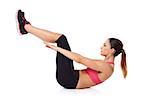 Woman execising her abdominal muscles lying on her back on the floor doing sit ups while holding her legs raised in the air over white