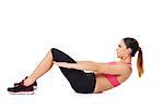 Fit young woman working out in a gym doing sit ups to strengthen her abdominal muscles on white