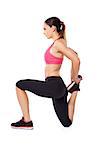 Woman athlete doing a workout kneeling to flex and stretcg her leg muscles for improved mobility, studio portrait on white