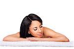 Beautiful happy female face, woman laying relaxing on white towel at spa massage beauty treatment parlor. Healthy Skincare concept, isolated.