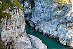 blue alpine river between two cliffs