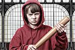Young aggresive teenage boy with a baseball bat