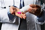 Closeup on medical doctor woman empty medicine bottle in hand