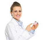 Smiling kosmetist woman pointing on creme