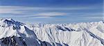 Panorama of snowy mountains in nice day. Caucasus Mountains, Georgia, view from ski resort Gudauri.