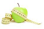 Green apple and yellow measuring tape isolated on white background