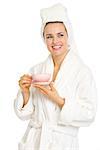 Smiling young woman in bathrobe with cup of coffee