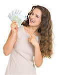 Smiling young woman pointing on euros