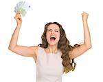 Happy young woman with euro banknotes rejoicing success