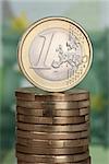 One Euro coin on a stack of Euro coins