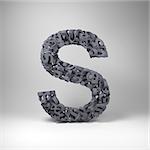 Letter S made out of scrambled small letters in studio setting