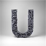 Letter U made out of scrambled small letters in studio setting