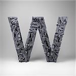 Letter W made out of scrambled small letters in studio setting