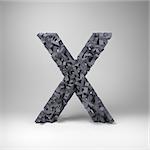 Letter X made out of scrambled small letters in studio setting
