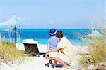 relaxed father and son together at the tropical beach